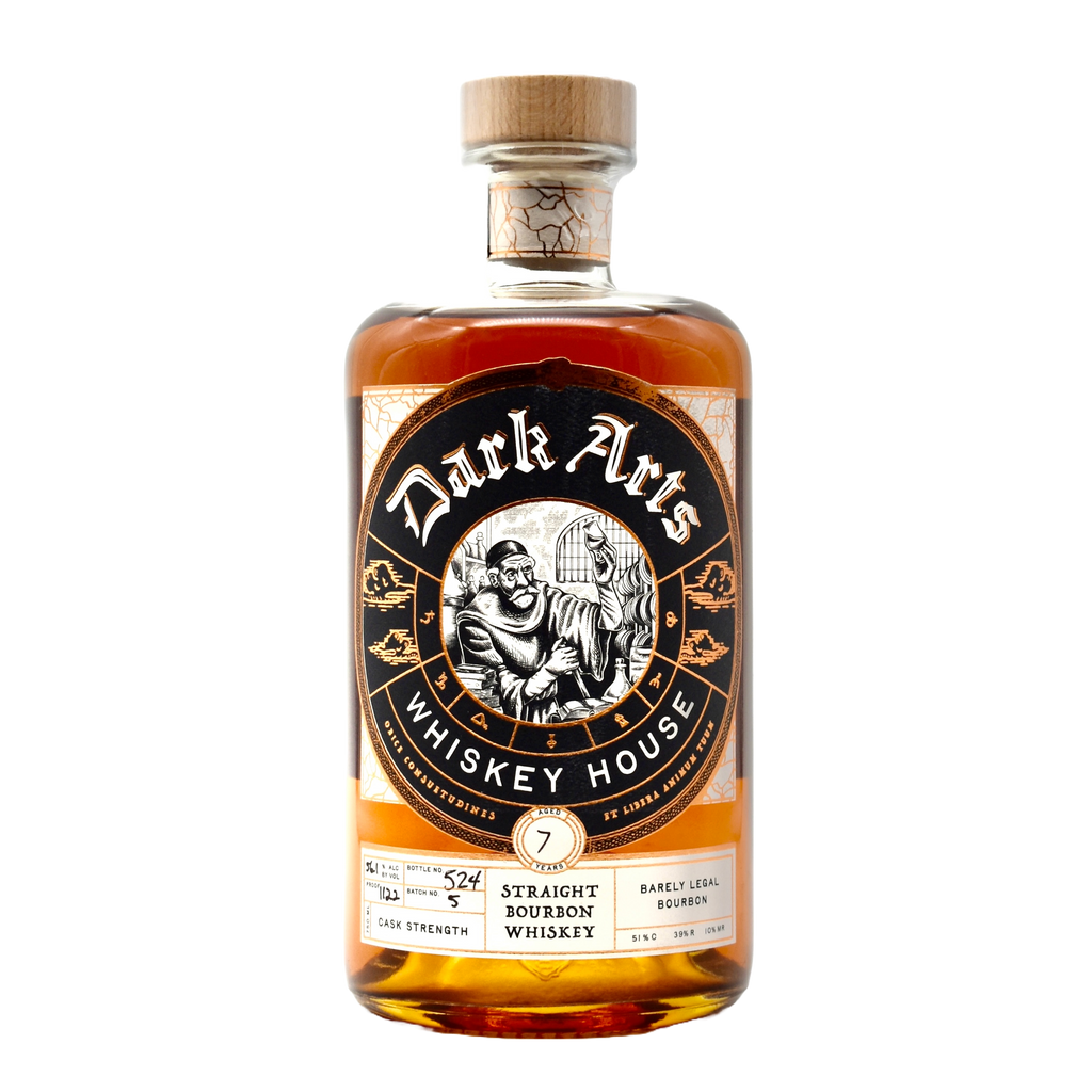 A bottle of Dark Arts Barely Legal Bourbon with a label featuring a skull and some ornate designs, predominantly in black, gold, and brown colors.